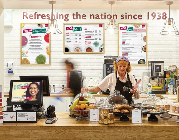 Royal Voluntary Service volunteer serving at the hospital cafe in Kingston, Surrey